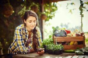 picture of a woman on the phone in a garden 